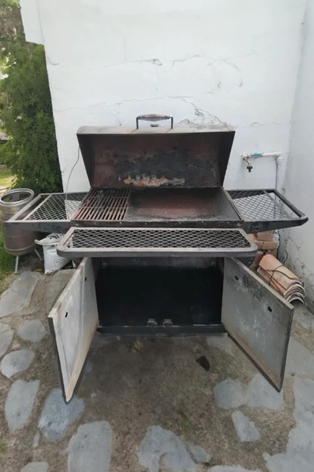 rusted steel bbq with doors outdoor